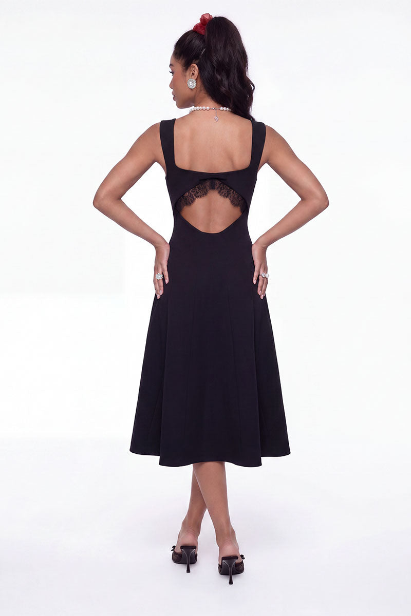 Black Nana Jacqueline Delilah midi dress with cut-out details, shown on a model in a stylish fashion shoot.