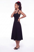 Black Nana Jacqueline Delilah midi dress with cut-out design, shown on a model in a stylish lookbook photo.