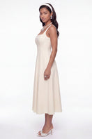 Nana Jacqueline Delilah white midi dress with cut-out design, elegant style, shown on a model against a neutral background.