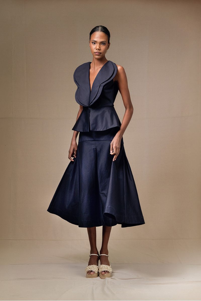 Navy blue DELLA top by ANA + MARIA, featuring a stylish, fitted design with soft fabric and a round neckline.