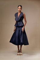 Navy blue Della top by ANA + MARIA displayed on a model, featuring a stylish, fitted design perfect for casual or chic outfits.
