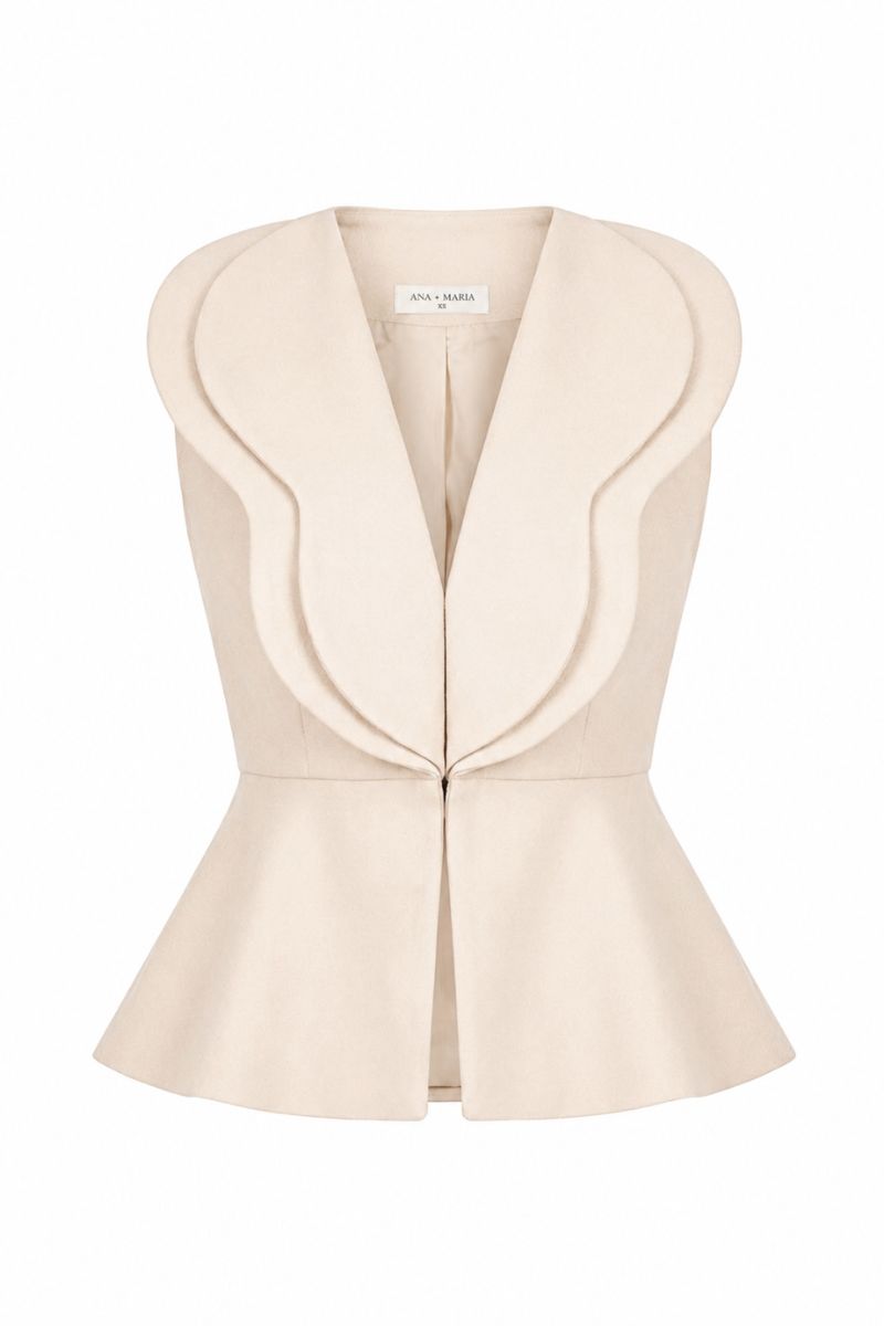 Beige Della top by ANA + MARIA displayed on a mannequin, showcasing its fit and simple design in a neutral sand color.