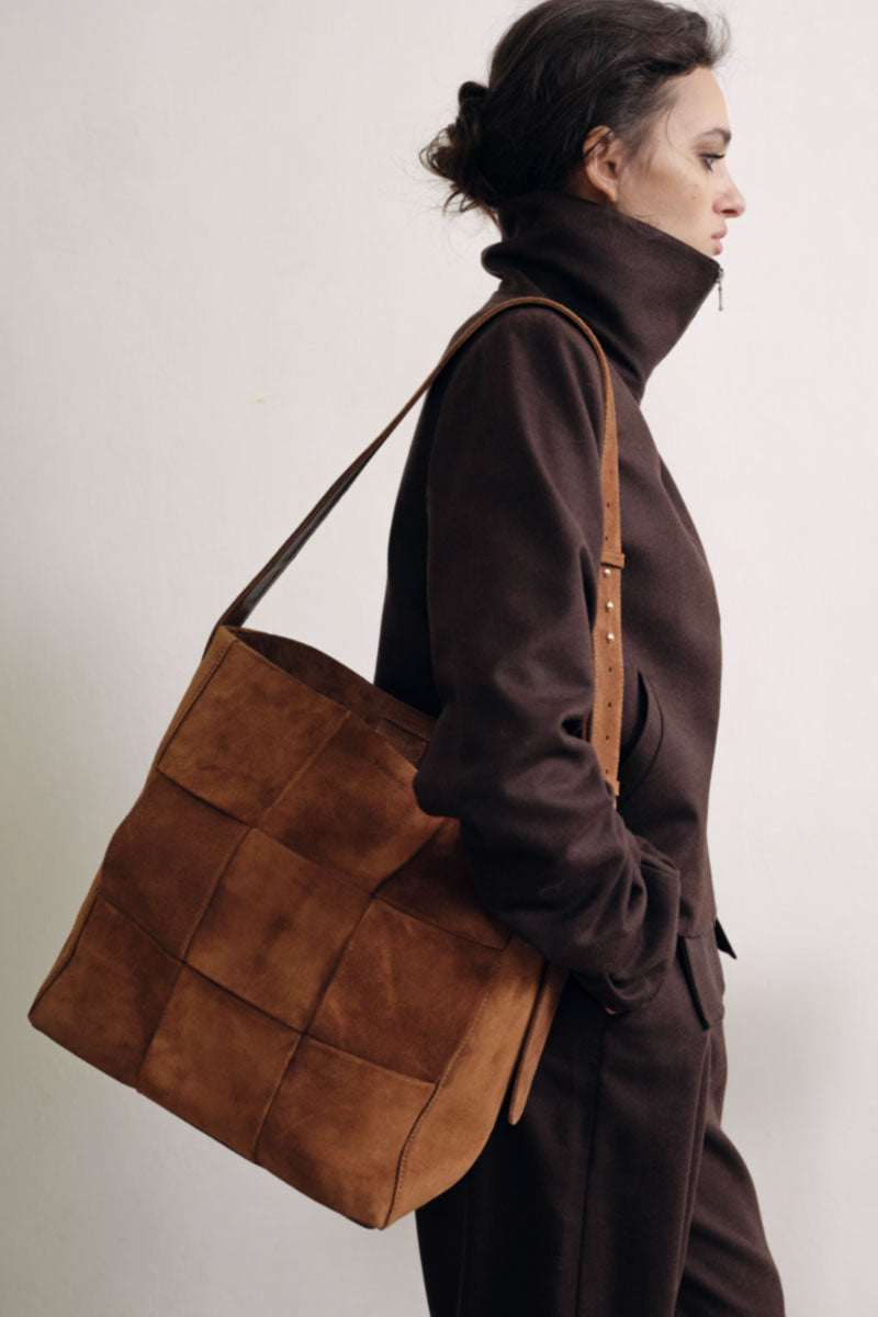 TUEAM'S Della shopper shoulder bag in light brown suede, showcasing its spacious design and soft textured material.