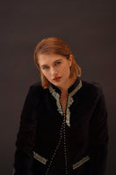 Nadya Shah Delphine velvet jacket displayed on a hanger, showcasing its luxurious deep blue velvet fabric and tailored design.