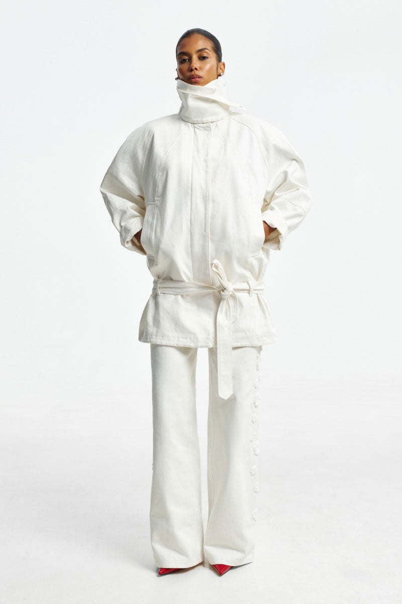 White denim jacket by Santa Brands, featuring classic style and button-front design, shown on a hanger.