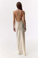 Serenity Deniz butter-cream halter-neck silk-satin maxi dress displayed on a mannequin with flowing fabric and elegant design.