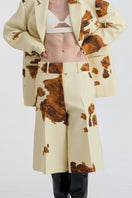 JINSUN printed wool silk Bermuda shorts in pale yellow with a detailed close-up of the fabric and pattern.