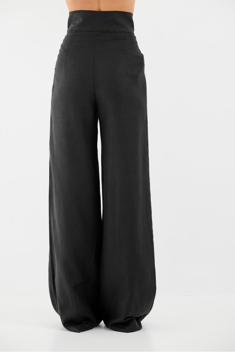 Tamar Keburia Diane black pants featuring a sleek, tailored design with a high waist and slim fit, shown on a model.