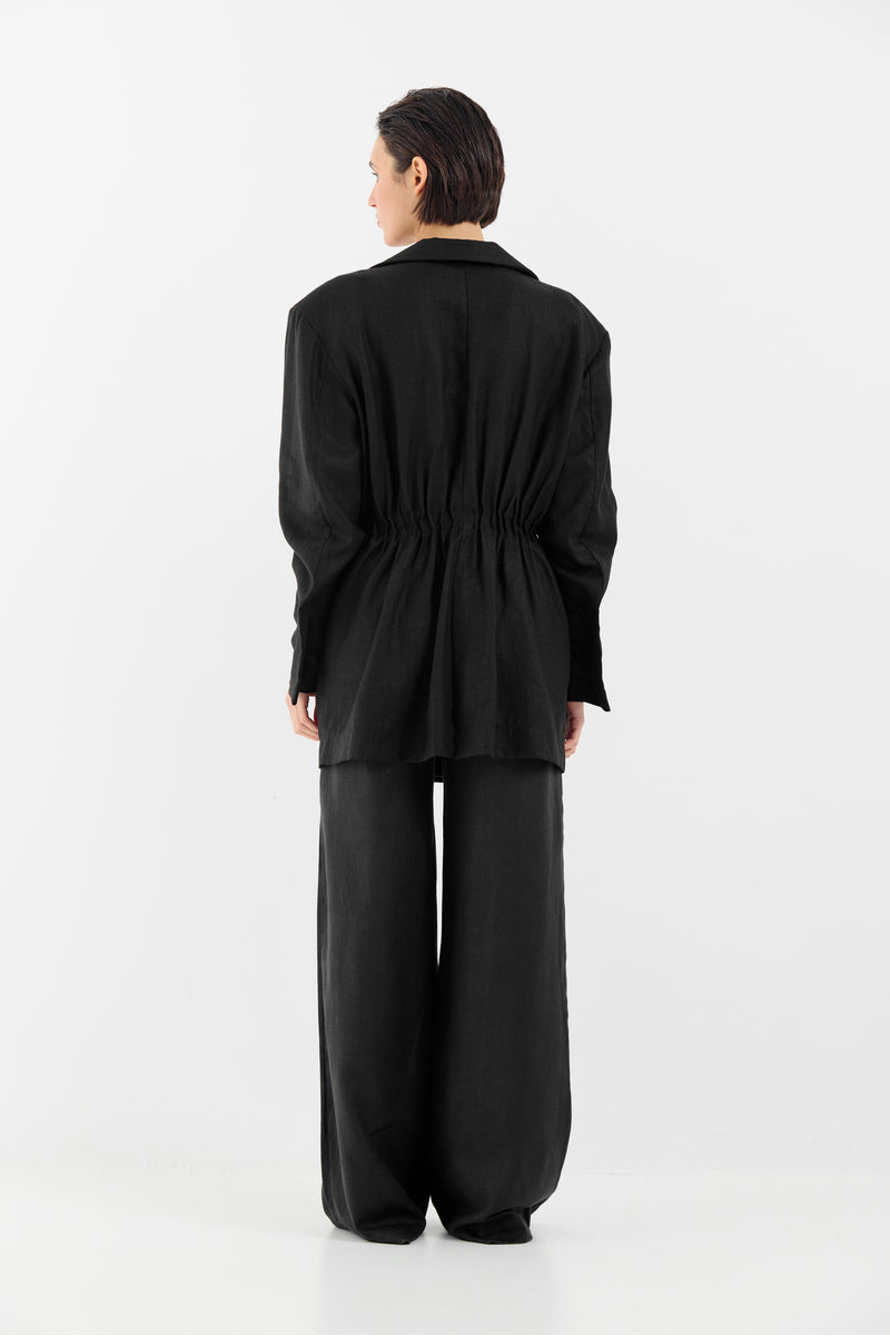 Tamar Keburia Diane black pants featuring a slim fit and stylish design, shown on a model with a neutral background.