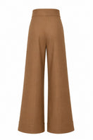 Ana + Maria Pino pants in tan, stylish and comfortable pants with a relaxed fit, shown in a natural fabric display.