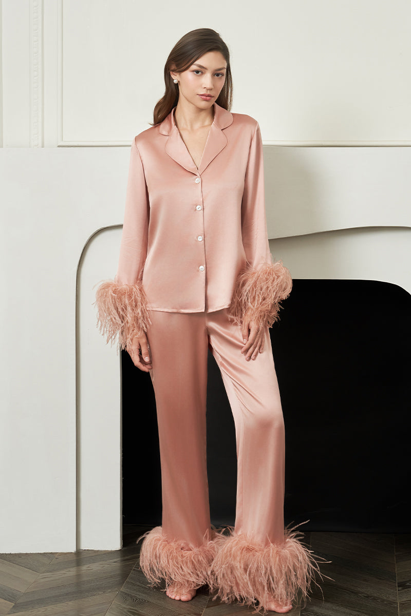 Coral feather-print women's pajama set by MANITO featuring a comfortable top and matching bottoms for relaxed sleepwear.