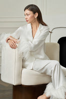 White feather-print women's pajama set by MANITO featuring a comfortable, stylish design for relaxed sleepwear.