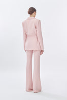Pink doll suit jacket from Stolen Stores featuring a classic long pants design, shown from the back on a model.