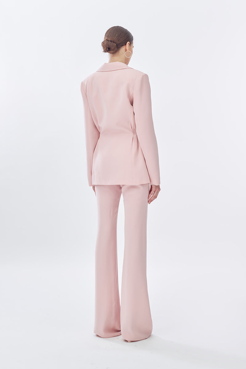 Pink doll suit jacket from Stolen Stores featuring a classic long pants design, shown from the back on a model.
