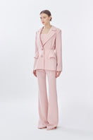 Pink suit jacket from Stolen Stores, featuring a classic long design, displayed on a doll with front view and long pants.
