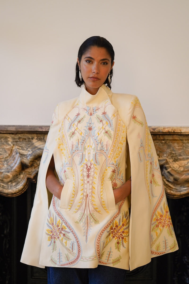Nadya Shah Dorian Ivory Cape jacket with flowing fabric and elegant design, displayed on a mannequin against a neutral background.