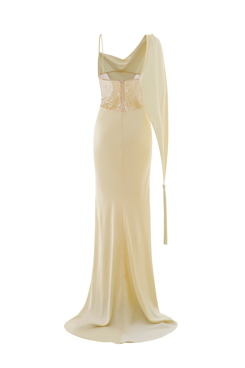 Pastel yellow POEM dormeuse gown hanging on a wooden hanger, showcasing soft fabric and elegant design.