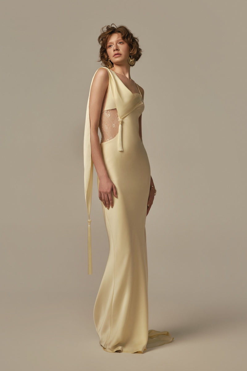 Pastel yellow POEM dormeuse gown displayed on model, featuring soft fabric and relaxed fit for comfortable, elegant wear.