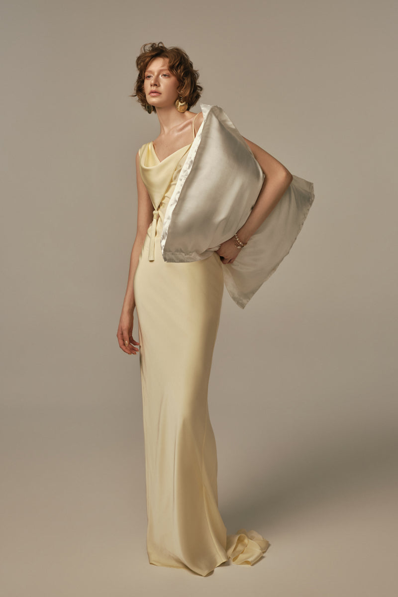 Pastel yellow POEM dormeuse gown displayed on model, featuring flowing fabric and elegant design for comfortable, stylish wear.