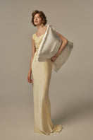Pastel yellow POEM dormeuse gown displayed on a model, featuring a flowing, elegant design perfect for stylish lounging or casual wear.