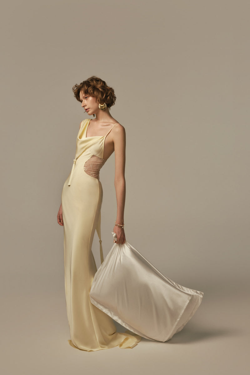 Pastel yellow POEM dormeuse gown featuring a flowing, elegant design with soft fabric and delicate details.