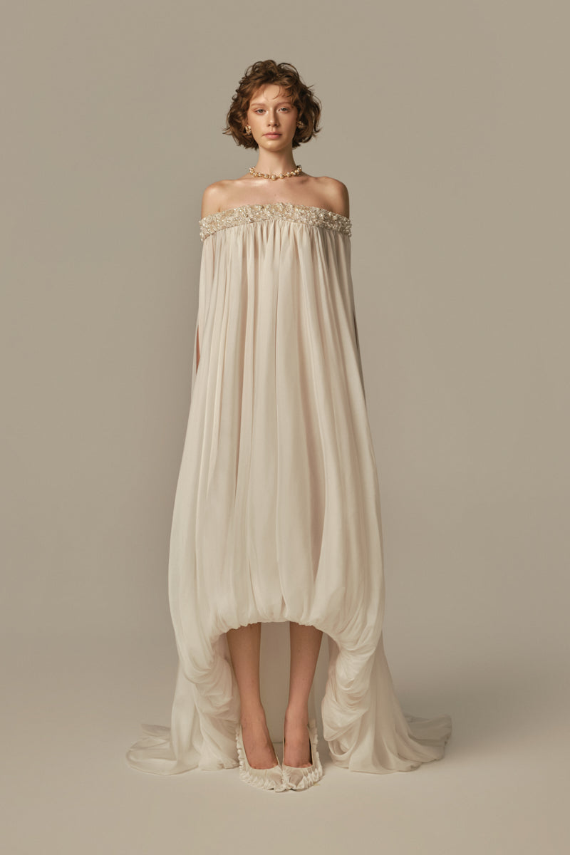 Poem Douceur Maxi Dress in white, flowing fabric with a relaxed fit, worn by a model showcasing elegant summer style.
