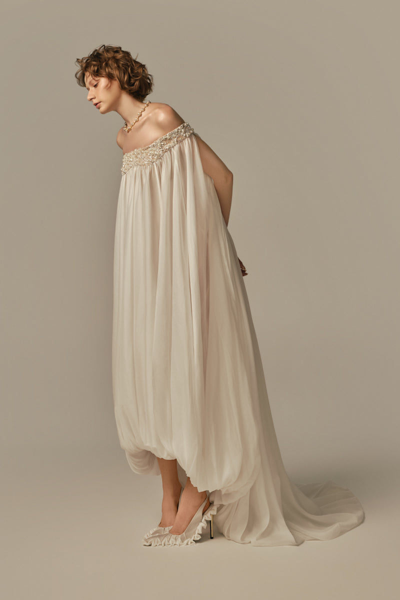 White POEM DOUCEUR Maxi Dress on a model, showcasing flowing fabric and elegant design for stylish summer wear.