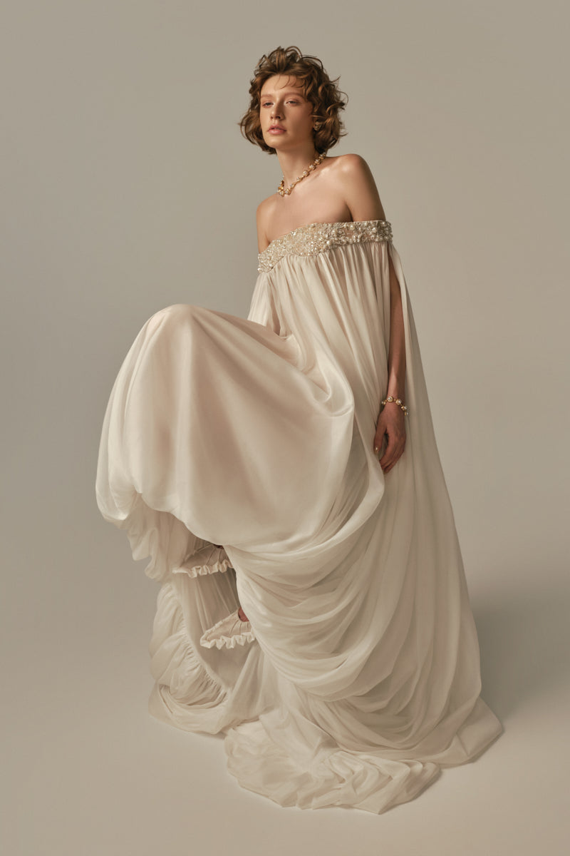 White POEM Douceur Maxi Dress displayed on model, flowing fabric and elegant design perfect for summer or formal occasions.