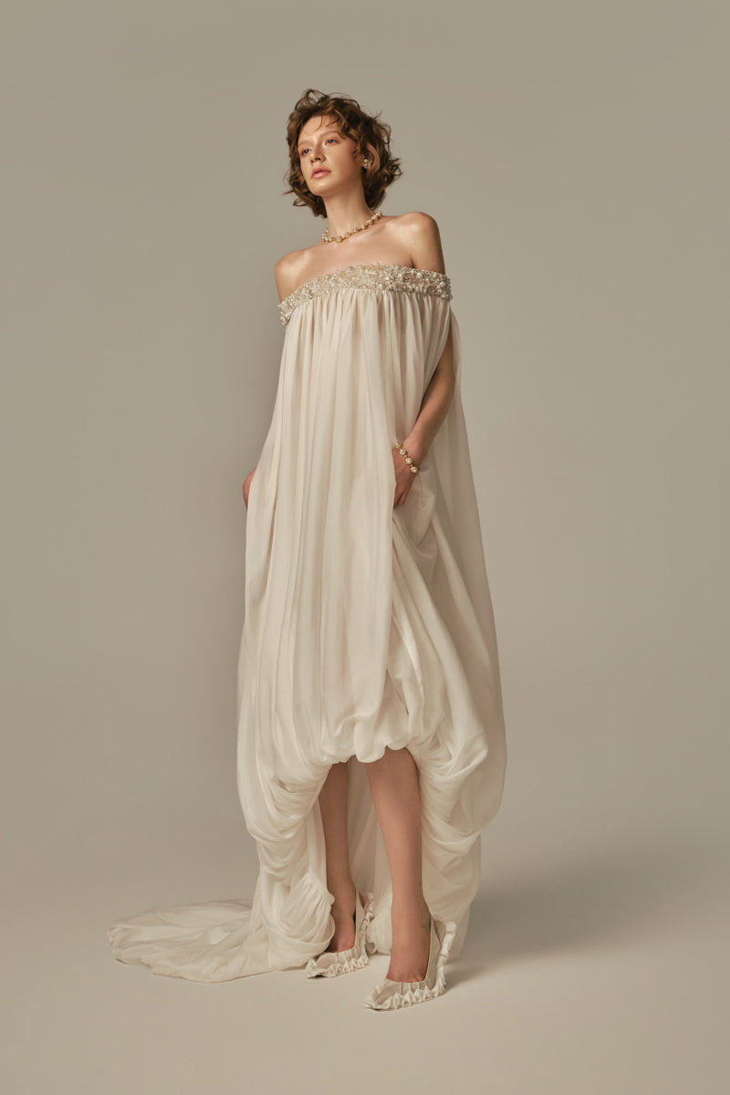 White POEM Douceur Maxi Dress on a model, featuring flowing fabric and elegant design for stylish summer wear.