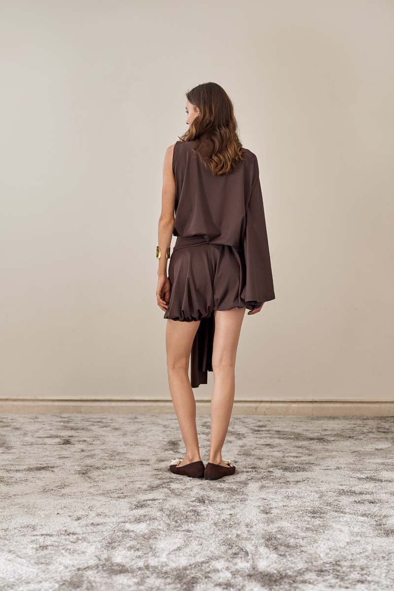 YASSMIN SALEH brown drape top shown from the back, soft fabric with elegant draping and long sleeves.