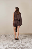 YASSMIN SALEH brown drape top shown from the back, featuring flowing fabric and stylish design for women's tops.