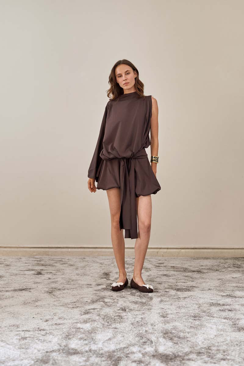 YASSMIN SALEH brown drape top with flowing fabric and stylish neckline, front view showcasing elegant design and relaxed fit.