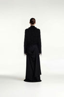 Black draped overlay maxi skirt by Tayfun Kaba, featuring flowing fabric and elegant design, shown in a stylish side view.