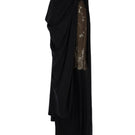 Black draped overlay maxi skirt by Tayfun Kaba, featuring elegant flowing fabric and layered design.