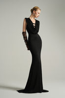 Black V-neck sleeveless gown by I.H.F Studio, featuring a draped cowl neckline and flowing jersey fabric.