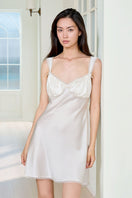 White silk chemise nightgown for women by MANITO, featuring smooth fabric and a relaxed fit, displayed on a hanger.