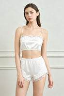 White silk lingerie set for women by MANITO, featuring elegant pajama design with delicate detailing and smooth fabric.
