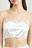 White silk lingerie set for women by MANITO, featuring elegant pajama design with smooth, luxurious fabric and delicate details.