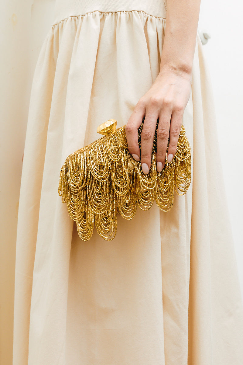 Gold Drip Box clutch by Sarah's Bag, stylish gold-toned leather evening bag with a drip design and compact size.