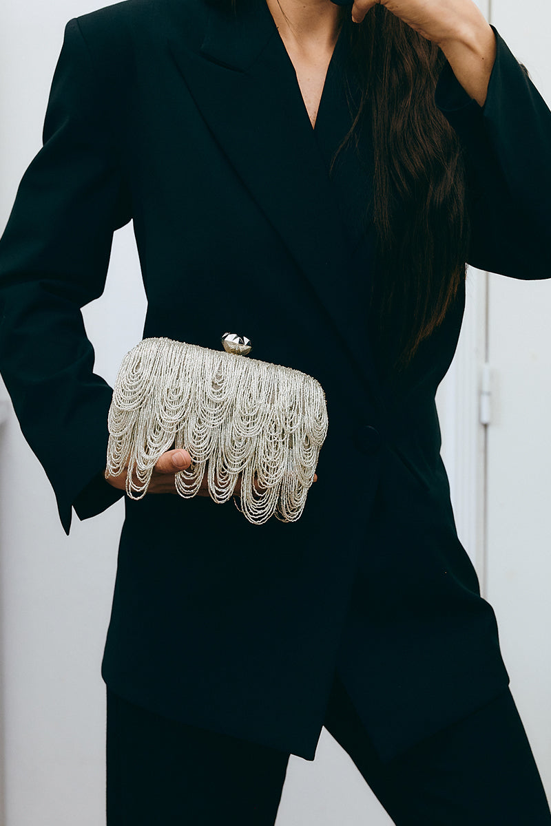 Silver drip clutch bag by Sarah's Bag, stylish metallic box clutch with a sleek design and modern elegance.