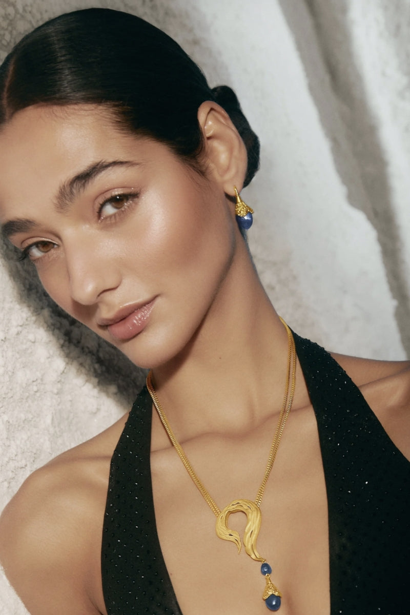 Gold and blue droplet earrings by Jude Benhalim featuring sleek, teardrop-shaped design with a shiny finish.