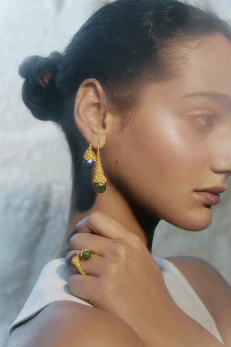 Blue droplet earrings by Jude Benhalim featuring gold accents, hanging from delicate hooks.