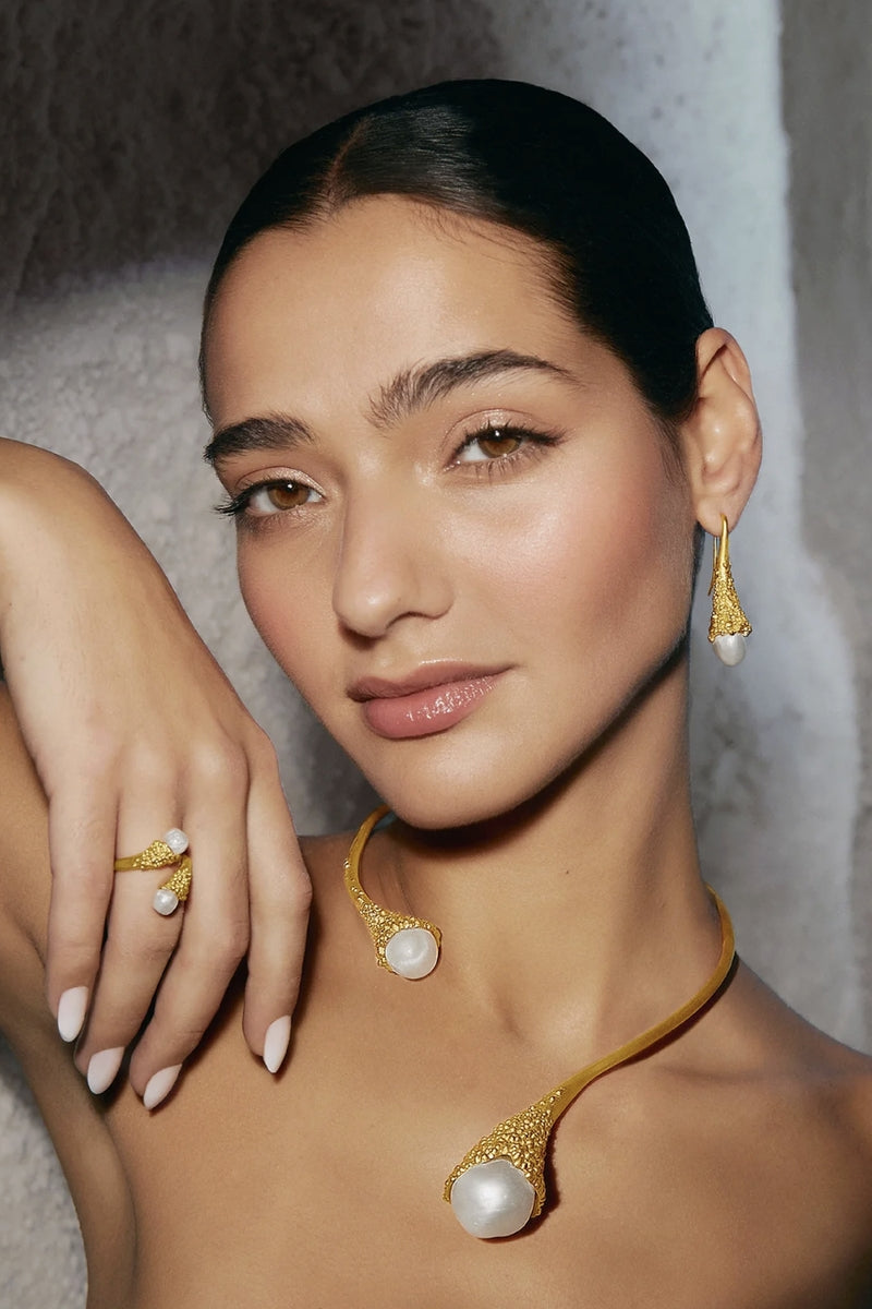 Gold and white droplet earrings by Jude Benhalim featuring elegant, teardrop-shaped design with a polished finish.