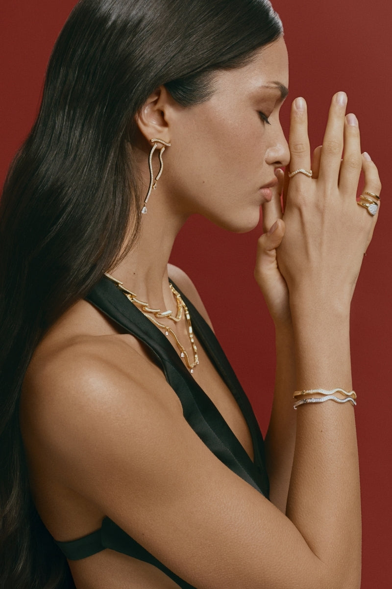 Silver Dune Mirage bangle bracelet by Velvet Desert with intricate desert-inspired design, worn on a wrist.