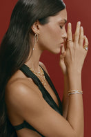 Silver Dune Mirage bangle bracelet by Velvet Desert with intricate desert-inspired design, worn on a wrist.