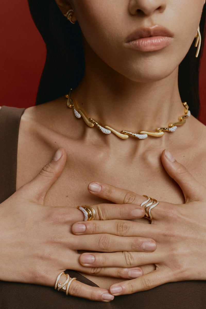 Gold DUNE RIMAL Satin Crest Necklace by Velvet Desert featuring a sleek, elegant design with intricate detailing.