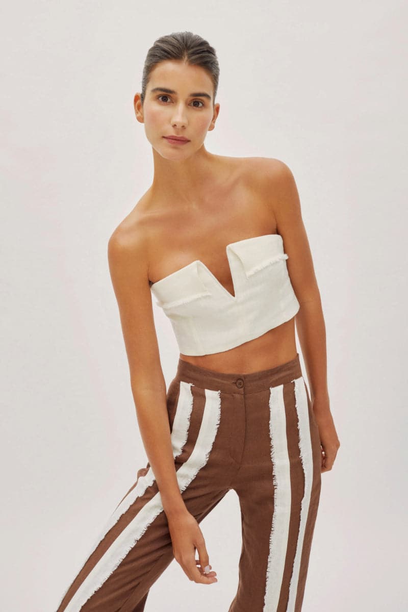 White linen V-neck crop top with fringe details from Labeca, featuring a stylish and breezy design perfect for summer wear.