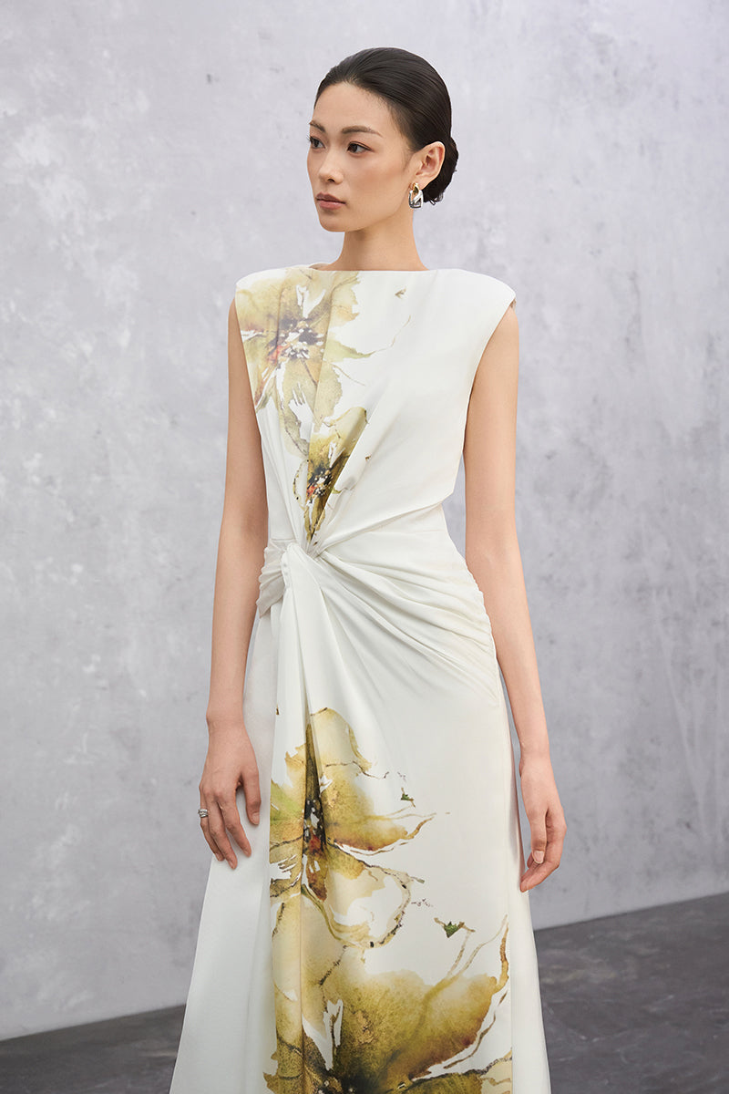 Off-white Florea maxi dress by EEGEN STUDIO displayed on a model, featuring flowing fabric and elegant design.