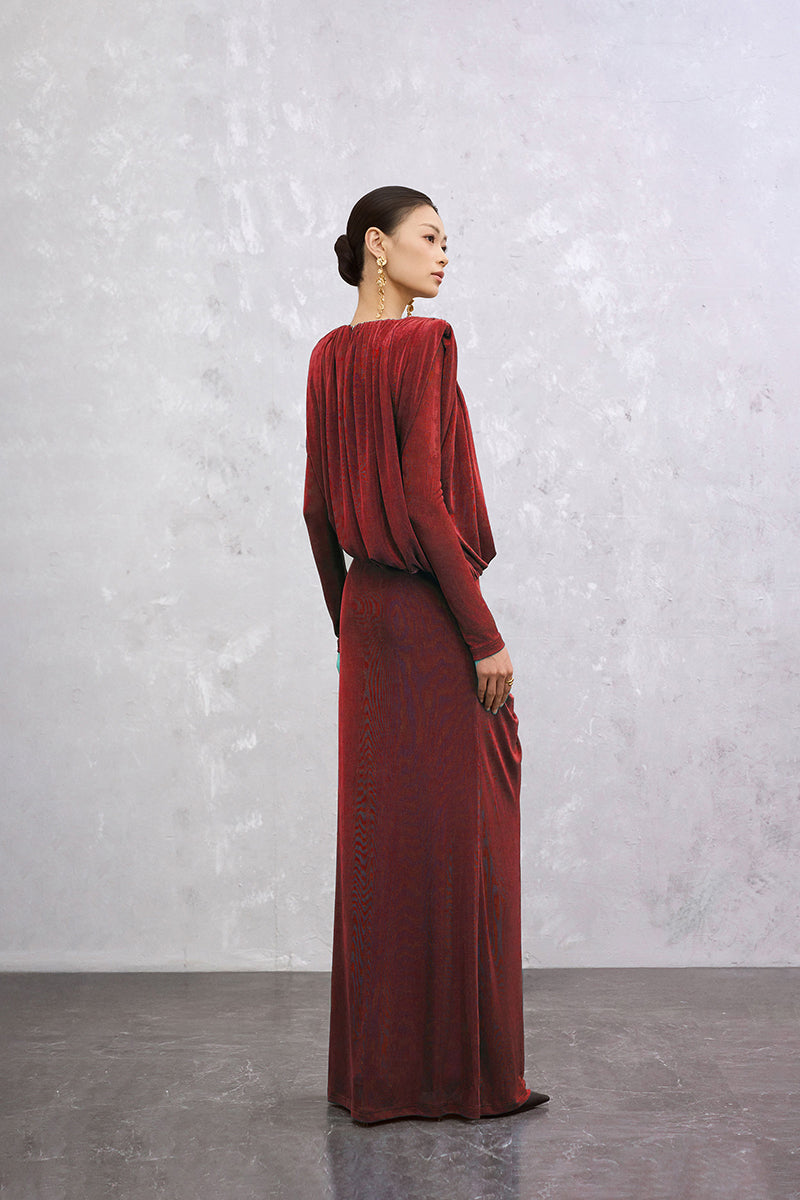 Red Seraphine maxi dress by EEGEN STUDIO, featuring flowing fabric and elegant design, shown on a model.