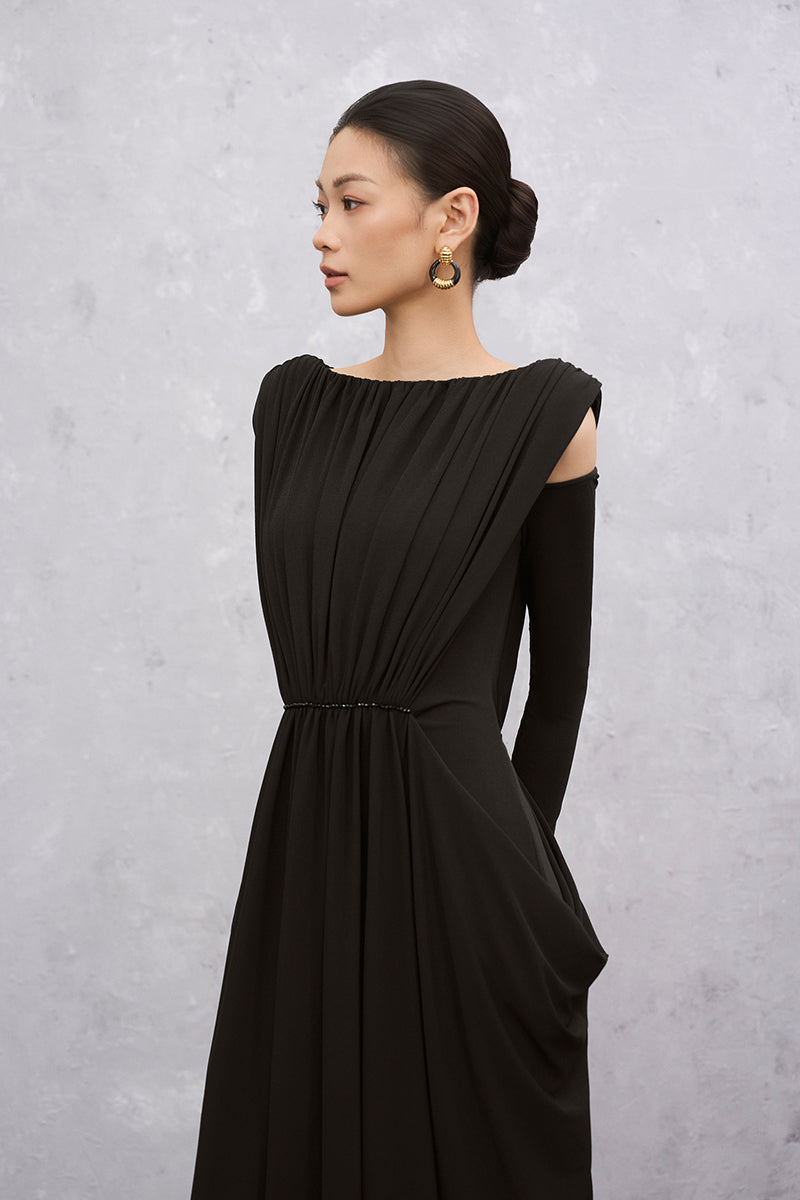 Black EEGEN STUDIO VELA maxi dress displayed on a hanger, showcasing its flowing fabric and elegant design.